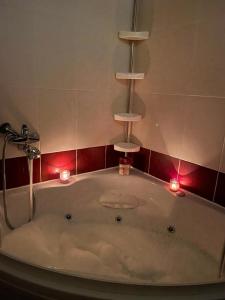 a bath tub with candles and lights in a bathroom at Luka-Mostar Free Parking in Mostar