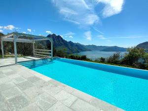 a swimming pool with a view of a lake and mountains at IseoLakeRental - Blue Note in Solto Collina
