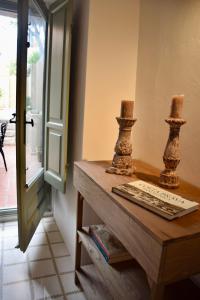 a table with two vases on it next to a door at Ca La Fesola in Palafrugell