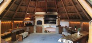 a large room with a fireplace and wooden walls at Wellness Penzion u Michala in Zuberec