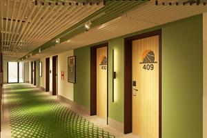 a hallway with green walls and basketball signs on the walls at IBIS Styles Kaunas Centre in Kaunas