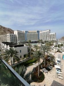 a view of a resort with palm trees and buildings at Three Bedroom Apartment at Address Residence Fujairah in Sharm
