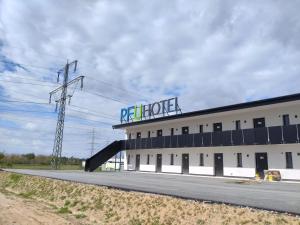 a building with a large sign on top of it at PFU Hotel by WMM Hotels in Pfungstadt