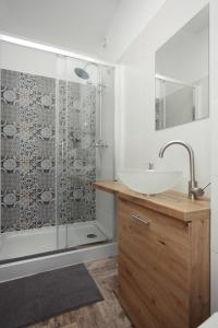 a bathroom with a sink and a shower at Apartamenty na Starym Mieście in Gliwice