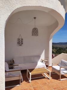 a living room with a couch and a chair at Vakantiewoning CasaLucka4enjoy private pool and mountain view regio Calpe-Jalon in Jalón