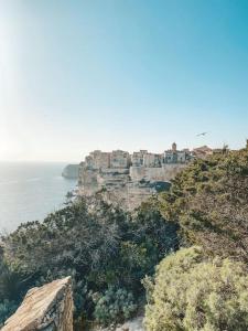 a village on top of a cliff near the ocean at Bonifacio : Studio au coeur de la citadelle in Bonifacio