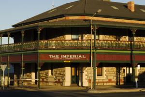 a building with a sign that reads the imperial at Imperial Fine Accommodation in Broken Hill