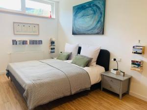 a bedroom with a large bed and a table at Ferienhaus Sonnenaufgang in Nohfelden