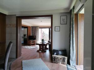a living room with a door open to a living room at Ferienwohnungen an der Hufeland-Therme in Bad Pyrmont