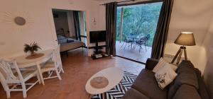 a living room with a couch and a table at Appartement sur golf de L'Isle-Sur-La-Sorgue in Saumane-de-Vaucluse