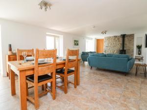 a living room with a table and chairs and a couch at Black Rock in St Austell