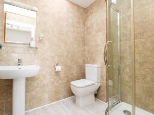 a bathroom with a toilet and a sink and a shower at Black Rock in St Austell +29 photos