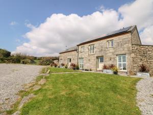 an old stone house with a large yard at Black Rock in St Austell