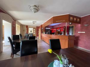 a restaurant with a table and chairs and a bar at Zajazd u Basi in Otyń