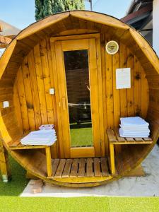 a wooden sauna with two benches in front of it at Balcsitthon Apartmanok in Siófok