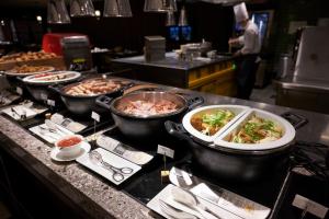 a kitchen with several dishes of food on a counter at Dhawa Yura Kyoto in Kyoto