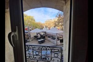 a view from a window of a patio with umbrellas at Superbe Appartement Rénové - Centre Historique in Montpellier