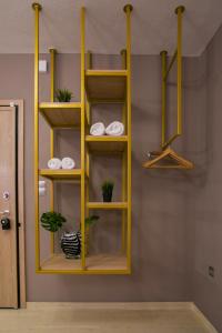 a yellow shelf in a room with some plants at Marizas luxury suites #1 in Thessaloniki