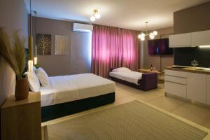 a hotel room with two beds and a kitchen at Marizas luxury suites #1 in Thessaloniki