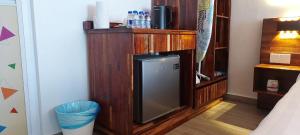 a room with a small television in a wooden cabinet at Coastal Bay Staycation in Dungun