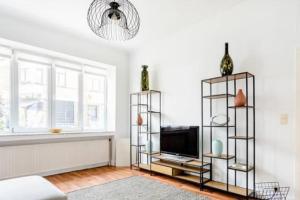 a living room with a flat screen tv and shelves at Family townhouse 3 bedrooms in Brussels