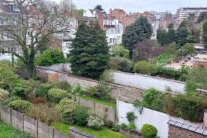 a garden on a brick wall in a city at Family townhouse 3 bedrooms in Brussels