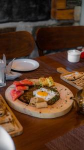 a plate of food with an egg on a table at Dumani Nagar Hotel & Resort in Hunza Valley