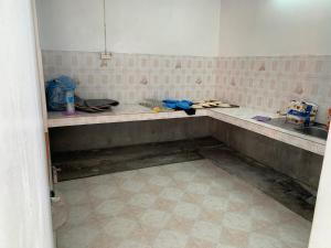 a dirty kitchen with a counter and a sink at NR appartments in Curepipe