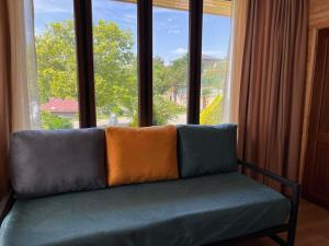 a couch sitting in front of a large window at Hotel Eurica in Kutaisi