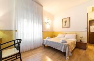 a bedroom with a bed and a chair at B&B Borgo Antico in Cava deʼ Tirreni