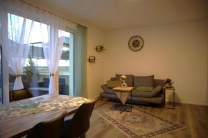 a living room with a couch and a table at Sorinas Home - Comfortable Apartment near Graz - Free Parking in Wagersbach