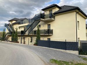 a house with a staircase on the side of a road at Sorinas Home - Comfortable Apartment near Graz - Free Parking in Wagersbach