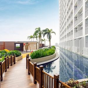 a view of a swimming pool in a building at Coast Residences Roxas Boulevard Manila in Manila