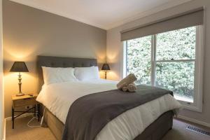 a bedroom with a large bed and a window at The Grange country retreat, with a birds eye view! in Mittagong