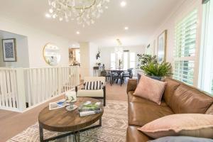 a living room with a couch and a table at The Grange country retreat, with a birds eye view! in Mittagong