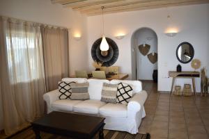 - un salon avec un canapé blanc et une table dans l'établissement Infinity View Villas Mykonos, à Kalo Livadi