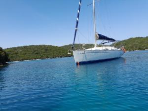 a white sail boat sitting in the water at Swing in Corfu