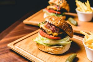 a sandwich on a cutting board with french fries at Dhawa Yura Kyoto - Banyan Group in Kyoto