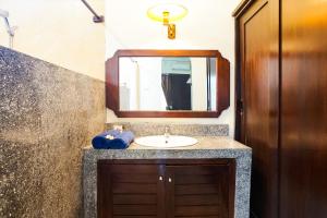 a bathroom with a sink and a mirror at Taman Ayu Legian Hotel in Legian