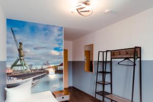 a bedroom with a bed and a view of a river at Restaurant und Pension Alberthafen in Dresden