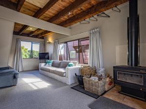 a living room with a couch and a fireplace at Alpine Delight - National Park Holiday Home in National Park