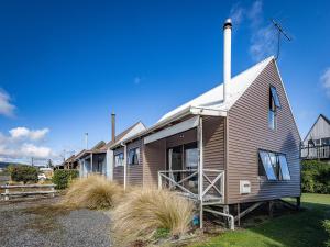 a house with a windmill on the side of it at Alpine Delight - National Park Holiday Home in National Park