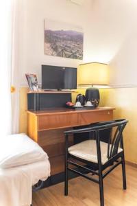 a room with a desk with a chair and a tv at B&B Borgo Antico in Cava deʼ Tirreni