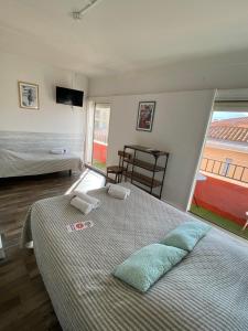 a bedroom with a bed and a large window at Hotel Les Pecheurs in Banyuls-sur-Mer