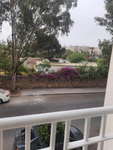 a balcony with a car parked on a street at Studio au bord de la corniche in Rabat