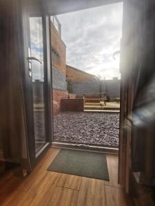 an open door with a view of a courtyard at Valletta House Holiday Apartments in Skegness