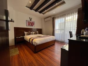 Ένα ή περισσότερα κρεβάτια σε δωμάτιο στο Hotel New Era