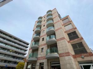 a tall building with balconies on the side of it at 5 Rent Lugano Center in Lugano