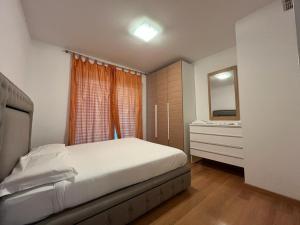 a bedroom with a bed and a dresser and a mirror at 5 Rent Lugano Center in Lugano