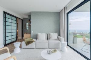 a living room with a couch and a table at The Marlo Luxury Suites by Totalstay in Cape Town